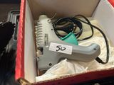 a box with a stapler and a stapler in it