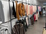 a lot of clothes hanging on a rack in a store