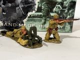 two figurines of soldiers with guns on a table
