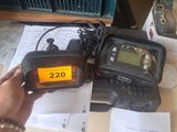 a person holding a radio that is sitting on a table