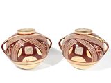 two brown vases sitting next to each other on a white surface