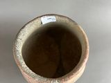 a close up of a vase with a tag on it