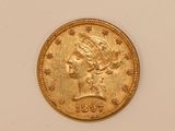 a close up of a gold coin on a white surface