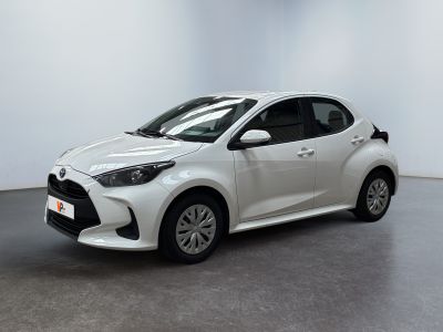a white toyota yaris parked in a white room