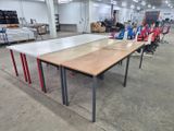 tables and chairs in a large warehouse with a lot of furniture