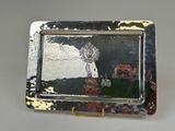 a silver plate with a picture of a man and a woman on it