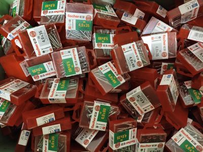 many different types of screws in a bin