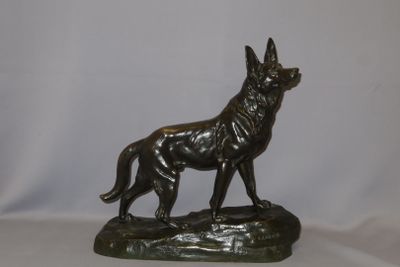 statue of a german shepherd dog on a rock on a white background