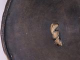 a close up of a metal plate with a hole in it