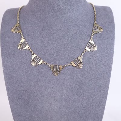 the necklace is made of silver metal and has a geometric design