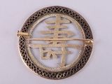 a picture of a brooch with a chinese symbol on it