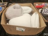 a box full of pillows and other items on the floor