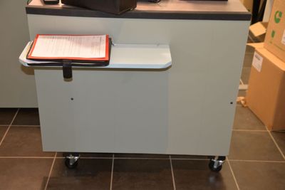 an image of a microwave on a cart in a kitchen