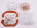 trois cendriers en verre et un cendrier en verre posé sur une surface blanche