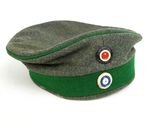 a green hat with a red and blue eye patch on it