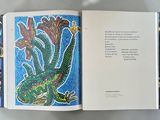 an open book with a picture of a dragon on it