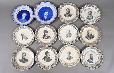 several plates with portraits of men and women on them on a table