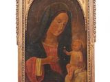 an old painting of a woman holding a baby in a gold frame