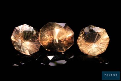 three different colored diamonds on a black surface
