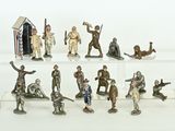 many figurines of soldiers on display on a white surface