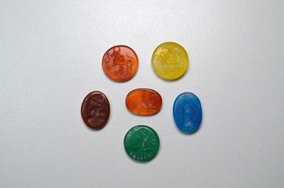 several different colored gummy bears arranged in a circle on a white surface