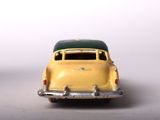 yellow and green toy car on white surface with white background