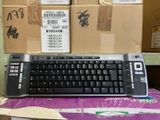 a computer keyboard sitting on top of a cardboard box