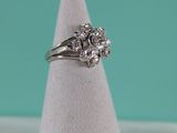 a close up of a diamond ring sitting on top of a white cone