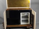 a small refrigerator that is open on a cart