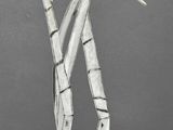 a metal sculpture of a woman holding a knife
