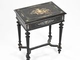 black and gold decorated side table on a white background