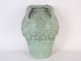 a green vase that is sitting on a white surface
