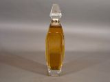 a small bottle of perfume sitting on a table