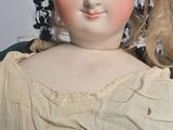a close up of a doll wearing a white dress