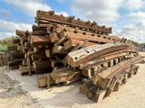 a large pile of wood sitting on the side of the road