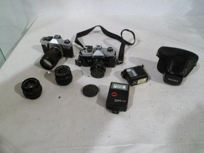a lot of cameras that are sitting on a table