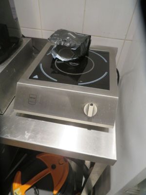 a stove with a pot on top of it in a kitchen