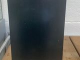 a black box on a wooden table with a window in the background