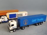 two toy trucks that are sitting next to each other