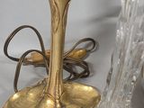 a candle that is sitting on a table next to a glass vase