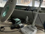an image of a desk with a computer and a magnifying light