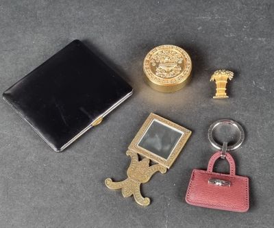 a keychain, wallet, key chain, and other items that are on a table