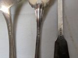 three spoons and two spoons on a table