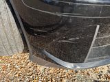 a close up of a car ' s front bumper and fender