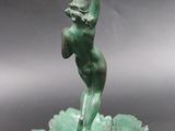 an image of a statue of a woman holding a frisbee in her hand