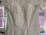 wedding dress hanging on a hanger in a bridal room