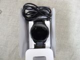 a white box with a black watch inside of it