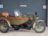 a motorcycle with a side car parked in front of a garage