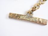 a gold plated necklace with a message on it