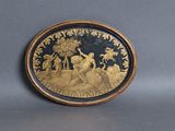 a gold plate with a picture of a man and a woman on it